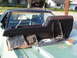 1973 Ford Ranchero - Disassembled interior parts are laid out on the hood of a green Ford Ranchero.