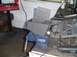 1993 Ford Bronco - A metal part is secured in a vise, surrounded by tools and workshop equipment.