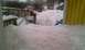 1989 Ford Bronco - A backyard scene covered in deep snow, with a wooden deck and a yellow structure visible.