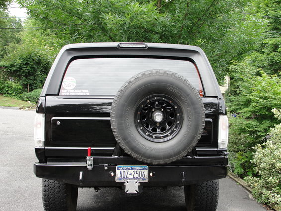 Rear view of a black 1995 Ford Bronco with a spare tire mounted on the tailgate
