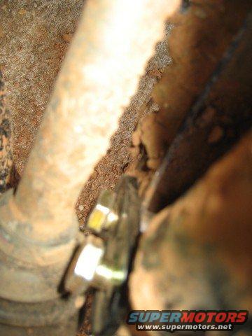 Close-up of an ATV suspension part, possibly a CV joint boot
