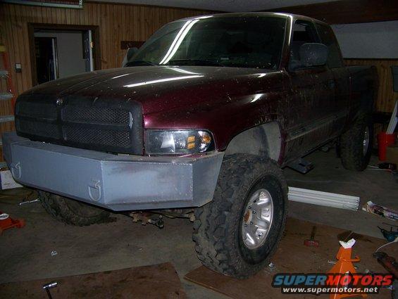 Maroon 2001 Dodge 1500 with custom front bumper and lift kit