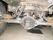 1984 Ford Bronco II - Underside view of a vehicle's rear axle and suspension system.