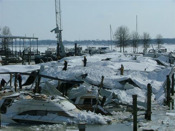 Boats and marina structures buried under snow and ice after a storm