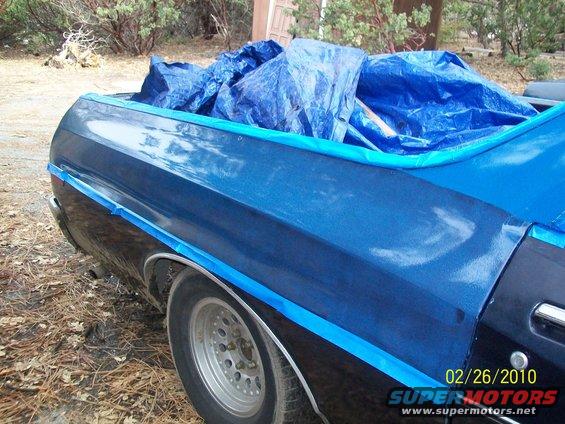 1973 Ford Ranchero rear quarter panel with blue tarp covering bed