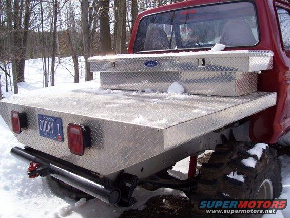 1978 Ford F-150 pickup truck bed with diamond plate flooring, toolbox, and Michigan license plate reading 'COCKY 1'