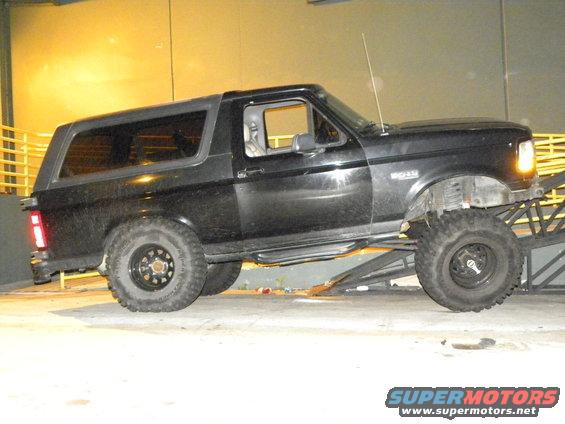 Black Ford Bronco with lifted suspension and off-road tires on a ramp