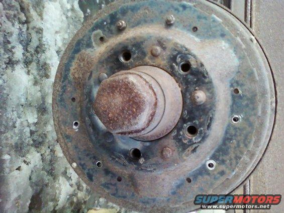 Rusty brake drum and hub assembly, likely from a truck or heavy vehicle