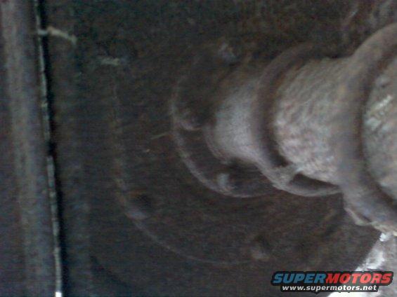 close-up of a rusty metal part on a vehicle's undercarriage