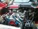 1984 Ford Bronco - Close-up view of a modified engine bay, showing a prominent carburetor and air intake system.