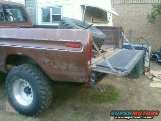 Rear quarter panel and open tailgate of a brown 1973 Ford F-Series pickup truck