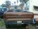 1976 Ford F-250 - Rear view of a brown 1976 Ford F-250 pickup truck, the Ford tailgate lettering and a spare tire in the bed.