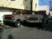 1976 Ford F-250 - Two older Ford trucks, a Bronco and a pickup, are parked in an alleyway.