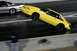 1992 Ford Mustang - A yellow fox body Mustang performs a wheelie during a drag race.