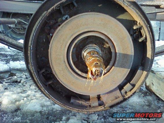 Close-up of a rusty truck brake drum with grease on the spindle