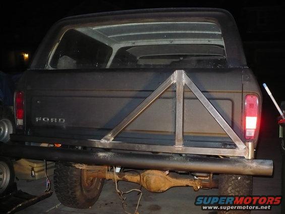 Dark SUV rear with custom triangular tire carrier and Ford badging. 1979 Ford Bronco
