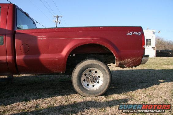 Side view of red pickup truck with 4x4 decal