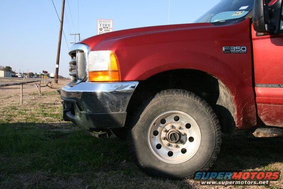 Red Ford F-350 Super Duty truck, front quarter view. F350 badge visible on fender