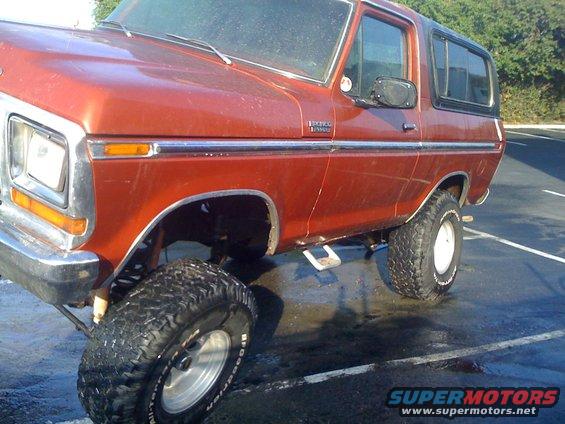 Red 1978 Ford Bronco with lifted suspension and off-road tires
