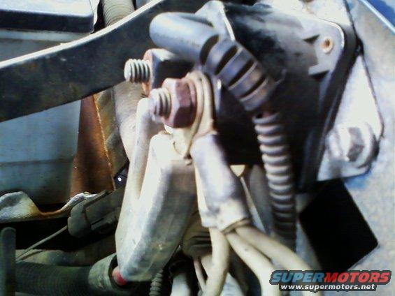 Close-up of starter motor wiring with bolts and electrical connectors