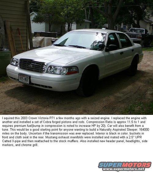 White Ford Crown Victoria parked outside a building. License plate reads 975-MUH