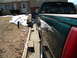 1995 GMC Sierra 1500 - A green pickup truck is parked on a concrete driveway next to a house with snow on the ground.