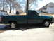 1995 GMC Sierra 1500 - A green 1995 GMC Sierra 1500 pickup truck is parked in a driveway on a sunny day.