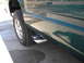 1995 GMC Sierra 1500 - Side view of a green truck, dual exhaust pipes and chrome body trim. The vehicle appears to be a 1995 GMC Sierra 1500.