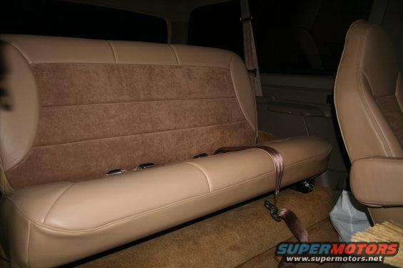 Tan interior with fabric and leather seats, seatbelts visible