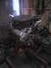 2001 Dodge 2500 - Engine assembly with visible belts and pulleys, mounted on a stand in a workshop.