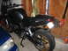 2008 Yamaha FZR1000 - A black motorcycle is parked in a garage with a leaf blower attached to its rear fender.