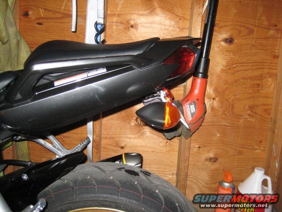 Motorcycle's rear fender eliminator with integrated turn signal and a leaf blower nozzle tucked behind it
