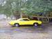 1971 Mercury Cyclone - A yellow coupe with a black lower body trim is parked outdoors near a wooden deck.