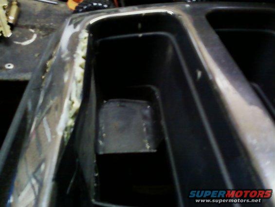 Chrome trim with yellow adhesive and black plastic interior