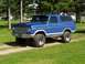 1979 Ford Bronco - This blue Ford Bronco features a prominent grille and lifted suspension, suggesting a model year prior to 1979.