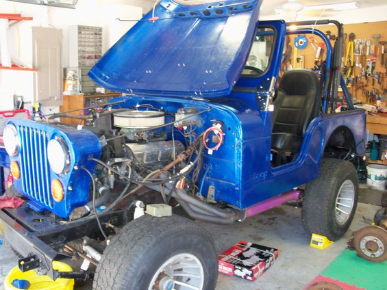 Blue 1978 Jeep CJ5 with hood open, showing engine and interior. Front view