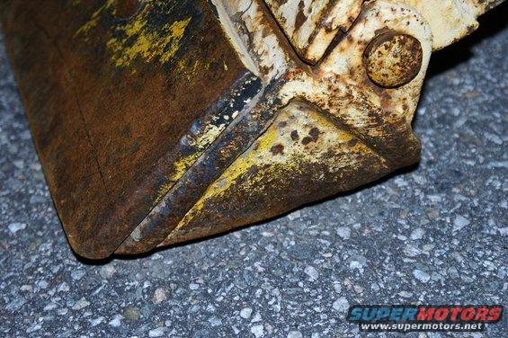 Rusted bucket with yellow paint remnants