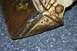1979 Ford Bronco - Close-up view of a heavily rusted bucket, showing signs of wear and yellow paint.