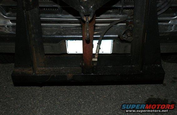 Rear view of a truck with a plow mount and hydraulic cylinder. License plate is visible