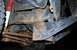 1979 Ford Bronco - Close-up view of heavily rusted vehicle frame and suspension components.