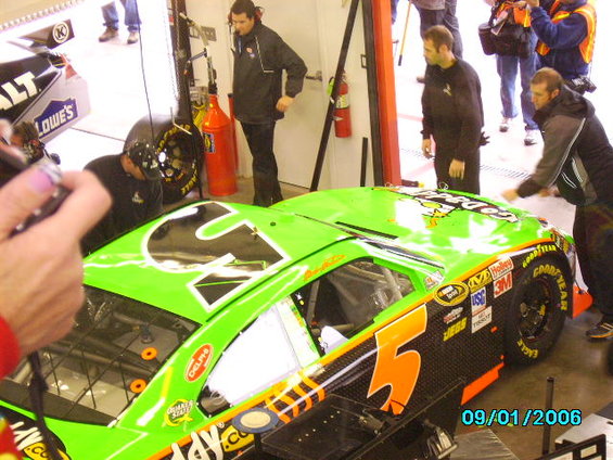 Green race car with large number 5 on the roof and side