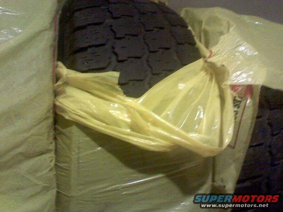 Tire wrapped in plastic and fabric