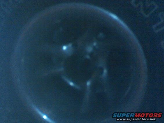 Close-up of tire tread with Supermotors.net logo