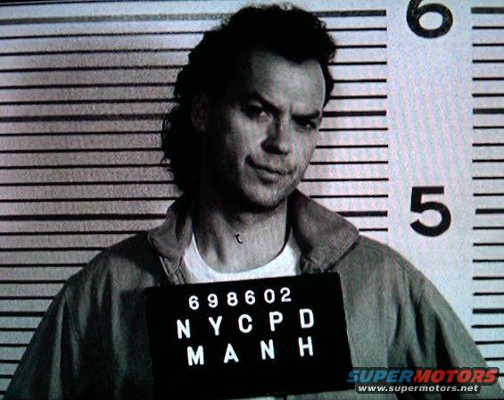 Mugshot of a man with a sign that reads 698602 NYPD MANH