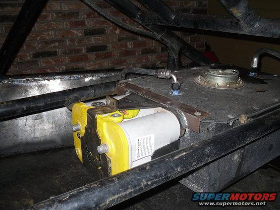 Fuel pump mounted to a fuel tank assembly with roll cage tubing visible
