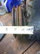 1977 Ford F-100 - Measuring a ribbed pulley with a tape measure on a workbench.