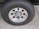 1993 Ford F-250 - Close-up of a truck wheel and tire assembly, showing aftermarket alloy wheels and a steeltex tire.