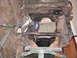 1970 Ford Mustang - This is a front view of a car frame, likely undergoing restoration or repair, showing significant rust and missing body panels.