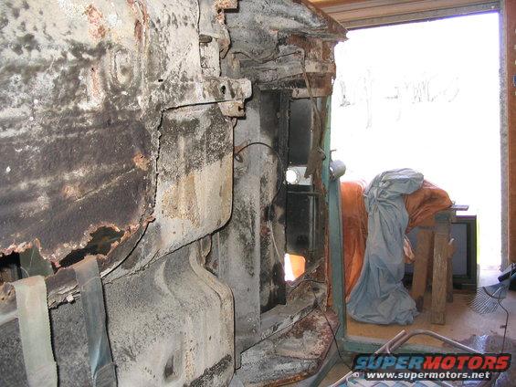 Heavily rusted vehicle frame, showing structural damage and decay