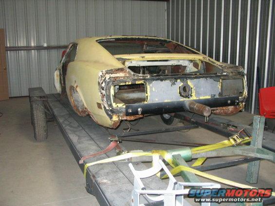 1970 Ford Mustang rear view, yellow, on trailer, rusted